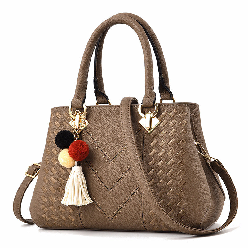 Embossed handbag with pompom charm