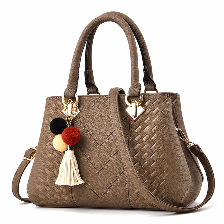 Embossed handbag with pompom charm