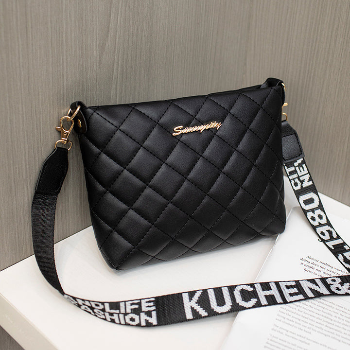 Black quilted crossbody bag with wide strap