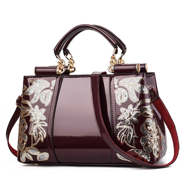 Sequin embroidered patent leather handbag