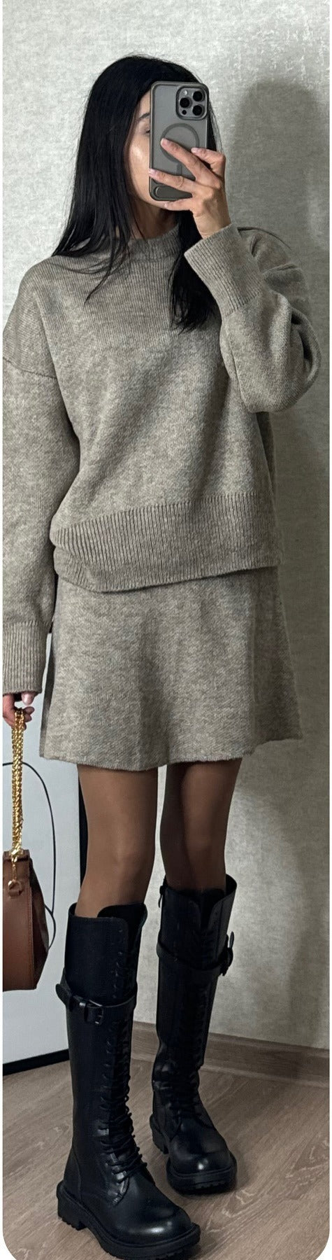 Woman in matching knit sweater and mini skirt set