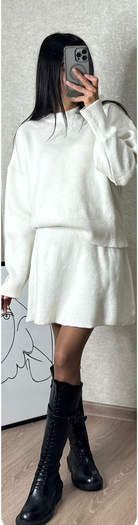 Woman in matching knit sweater and mini skirt set