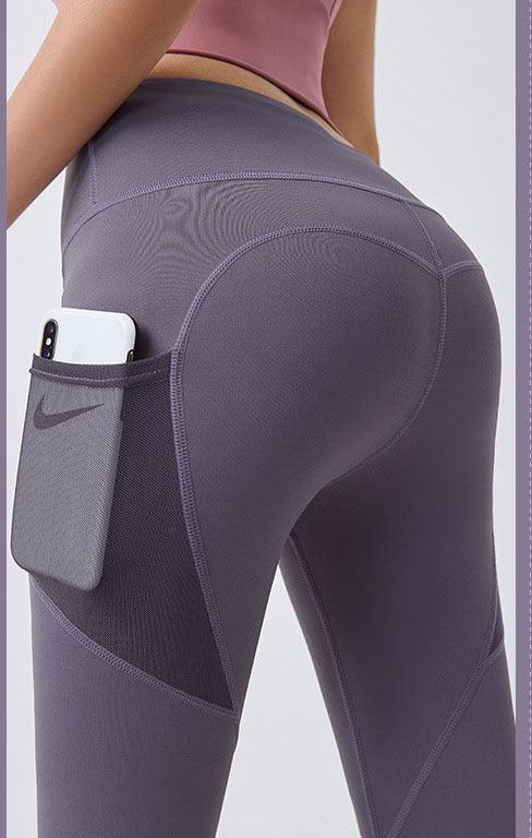 Woman wearing black high-waist leggings with phone pocket