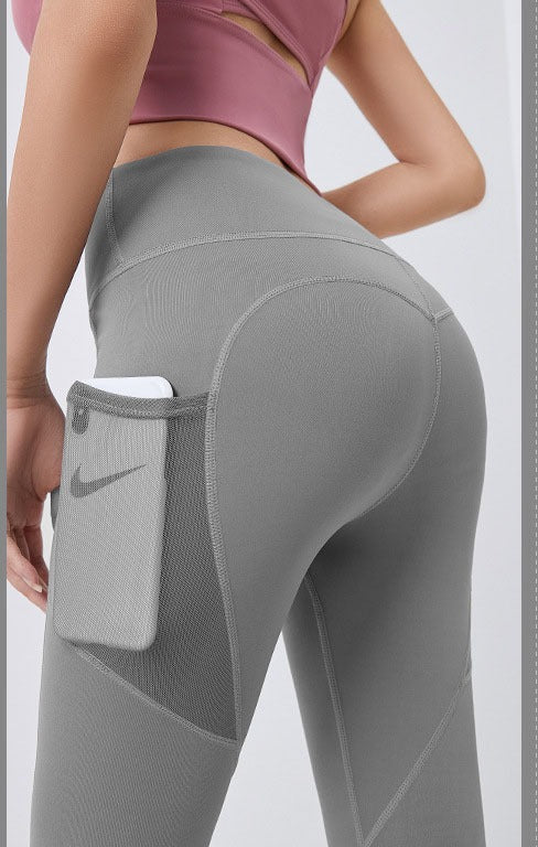 Woman wearing black high-waist leggings with phone pocket