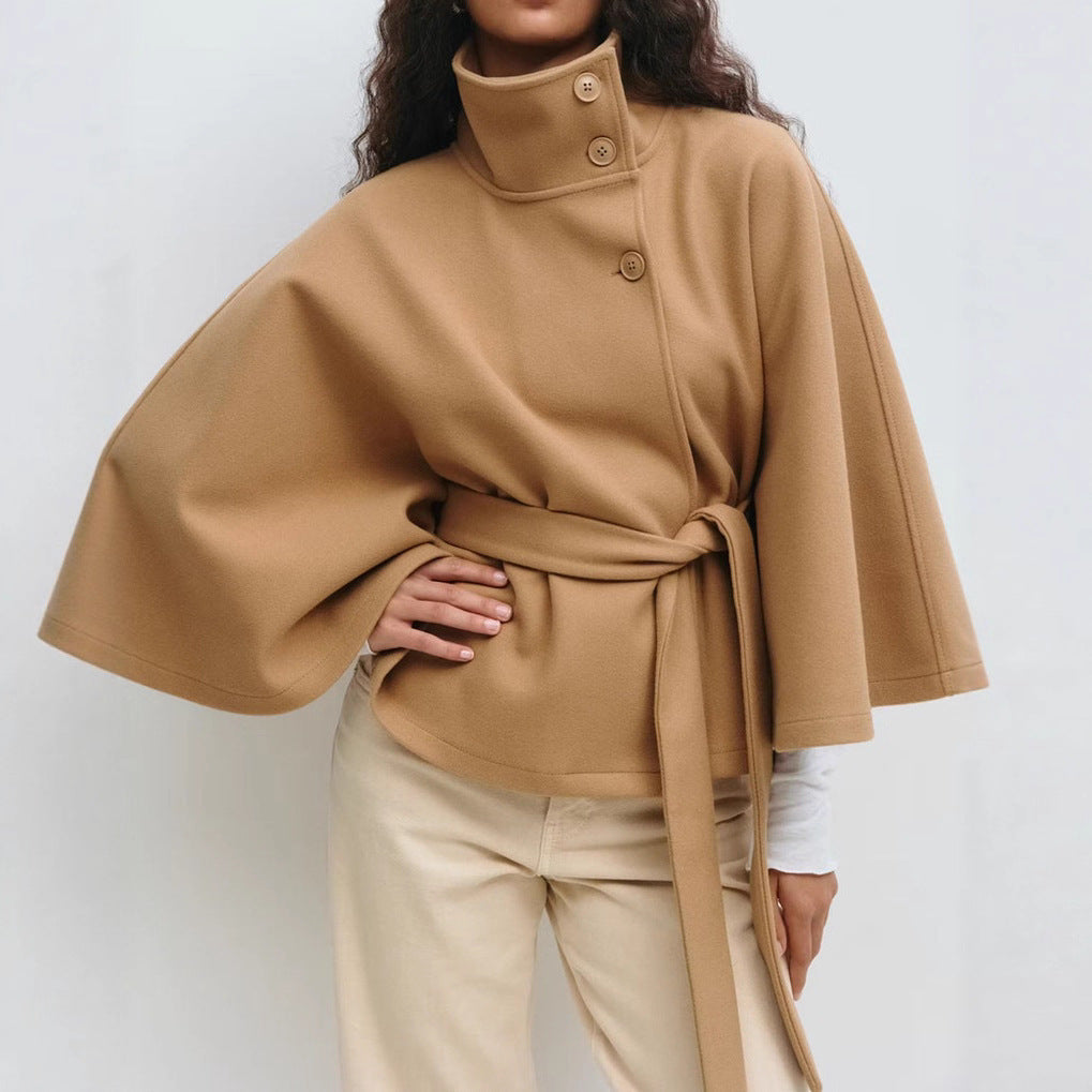 Woman in belted cape coat with high collar