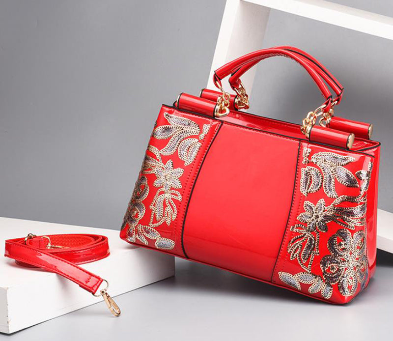 Sequin embroidered patent leather handbag