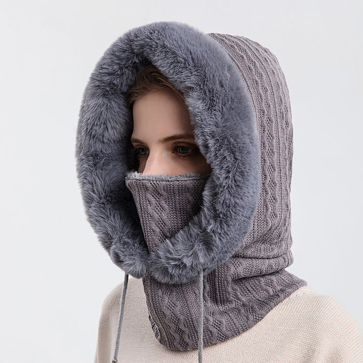 Woman wearing knit hood with faux fur trim