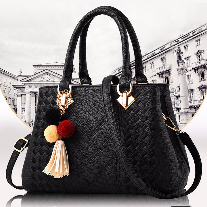 Embossed handbag with pompom charm