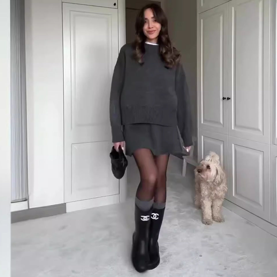 Woman in matching knit sweater and mini skirt set