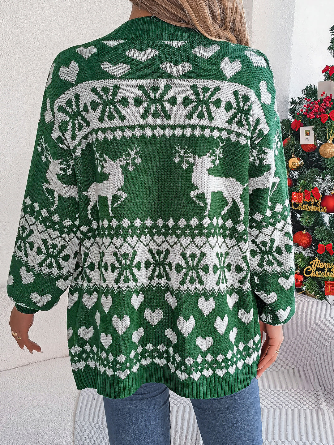 Woman in a reindeer knit cardigan