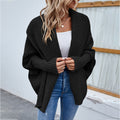 Woman in oversized batwing knit cardigan
